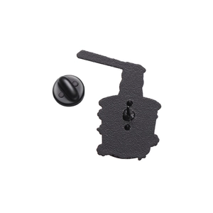 Detail view of the black metal enamel pin back with matte texture and rubber clutch