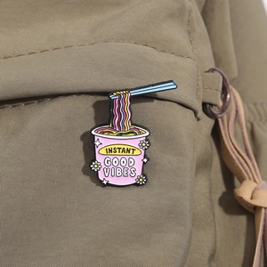 Rosa Instant-Nudel-Emaille-Pin mit Stäbchen an einer khakifarbenen Segeltuchtasche