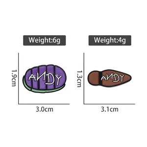 Enamel badges with Andy signature in purple and brown boot designs for toy fans