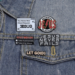 Set of 5 religious enamel pins with Christian slogans pinned on a blue denim jacket