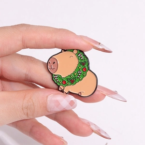 Cute Capybara enamel pin with Christmas wreath and candy cane on metal badge