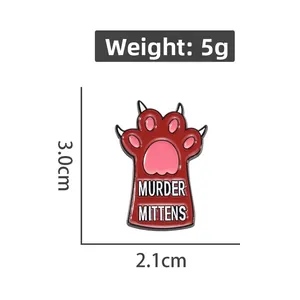 Detail view of cat paw enamel pin with size specs and Murder Mittens text