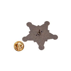 Detail view of hexagram metal badge back with butterfly clasp and alloy pin closure