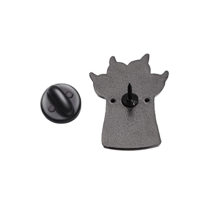 Detailed back view of a black metal cat paw pin with its rubber clutch and textured surface