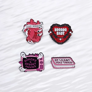 Halloween enamel pin set with anatomical heart, retro TV and spooky movie graphics