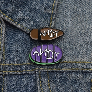 Cartoon enamel pin set with Andy lettering design on colorful shoe sole shapes