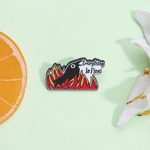 Cartoon fire bird enamel brooch with Everything Is Fine text on green background