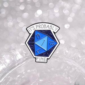 Blue gradient D20 enamel pin with It's Probably Fine text on white bokeh background