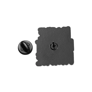 Macro view of black enamel brooch back with metal pin and rubber butterfly clutch closure