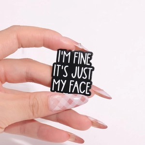 Enamel pin with 'I'M FINE IT'S JUST MY FACE' quote for backpacks and scarves