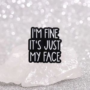 Classic black enamel brooch pin featuring funny white slogan I'M FINE IT'S JUST MY FACE