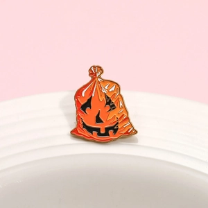 Funny Halloween pumpkin lantern enamel pin with orange garbage bag demon face design