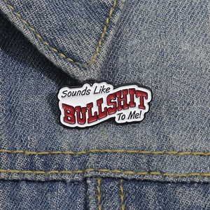 Makroaufnahme der 'Sounds Like BULLSHIT To Me!' Emaille-Anstecknadel an einer Jeansjacke