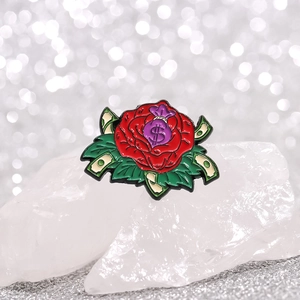 Enamel rose pin featuring a purple money bag with dollar symbol on a crystal base