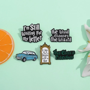 Five-piece magical themed enamel pin set featuring blue car and wizardry quotes