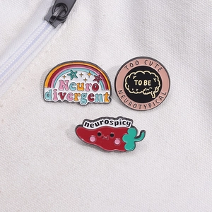 Set of 3 creative enamel pins featuring a red chili, rainbow, and brain-themed designs