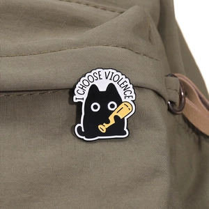 Funny cartoon black cat enamel pin with I Choose Violence text on green canvas bag