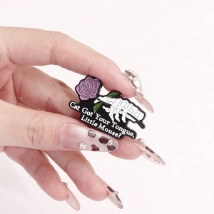 Halloween skeleton hand with purple rose enamel pin featuring cat got your tongue text