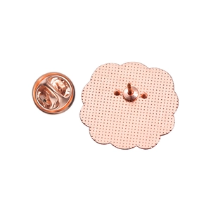 Detail of rose gold flower-shaped metal badge pin back with butterfly clasp