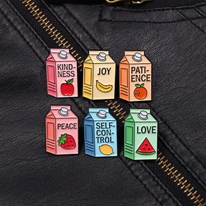 Detail of six colorful fruit milk carton enamel pins pinned on a black leather jacket