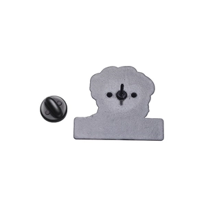 Détail du fermoir en caoutchouc noir et du support métallique d'un badge émaillé