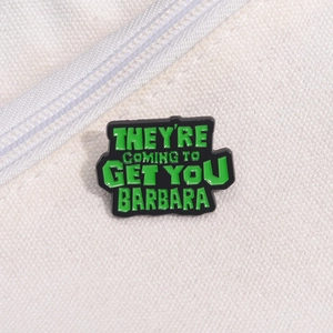Green punk enamel brooch with 'THEY'RE COMING TO GET YOU BARBARA' quote on white fabric