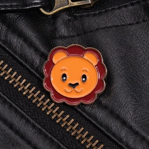 Detailed close-up of a cartoon lion enamel pin on a black leather jacket with brass zipper