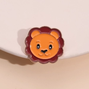 Cute cartoon lion enamel pin with orange face and red mane on gold metal base