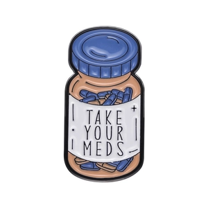 Cartoon enamel pill bottle brooch with Take Your Meds text and colorful capsule design
