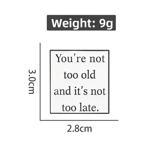 Square white enamel brooch with motivational quote showing 3.0cm height and 2.8cm width