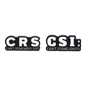 Black and white CRS and CSI enamel lapel pins with funny slogans on white background