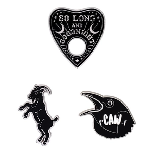 Three-piece gothic enamel pin set featuring a black goat, crow, and heart-shaped planchette