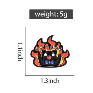 Detail shot of black cat enamel pin with LET IT BURN slogan and orange flames