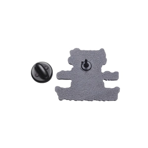 Detailed back view of a metal lapel pin with textured surface and black rubber clutch