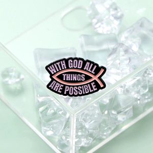 Black and pink enamel pin with fish symbol and motivational religious quote on ice cubes