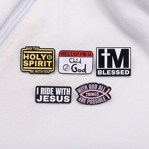 Set of 5 minimalist Christian enamel pins with Ichthys and text on white fabric
