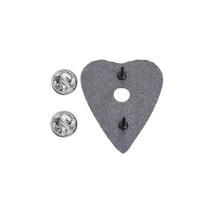 Macro view of heart-shaped punk enamel pin back with double needles and silver butterfly clutches