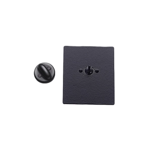 Square black metal badge back view with textured surface and butterfly pin fastener