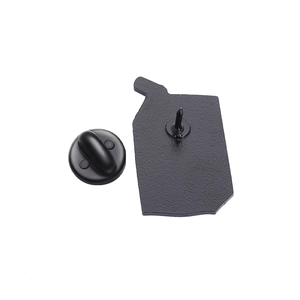 Macro view of the matte black enamel pin back with secure needle and butterfly clutch