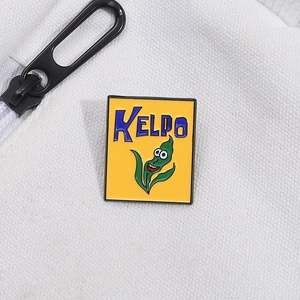 Macro shot of rectangular enamel kelp pin with KELPO text on white woven fabric