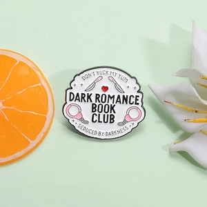 Dark Romance Book Club Emaille-Pin mit rosa Dolchen und Handschellen auf grünem Grund
