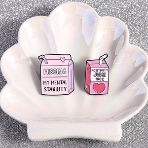 Pink enamel pins set with Positivity Juice and Mental Stability drink box designs