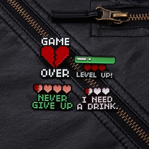 Detailed view of pixel art enamel pins on leather jacket showing game status designs