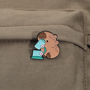 Detailed close-up of a cute capybara enamel pin using a microscope on a canvas bag