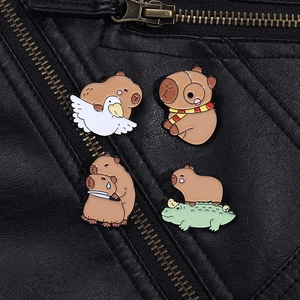 Close-up of four funny capybara enamel pins pinned on a black leather jacket lapel