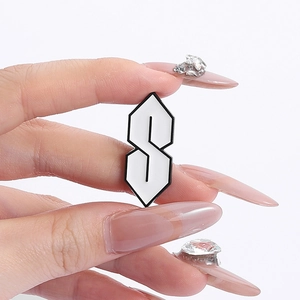 Minimalist black and white enamel pin featuring the classic 90s street culture Cool S design