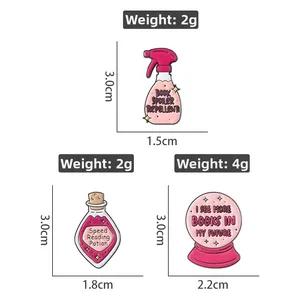 Macro detail of pink enamel pins featuring potion bottles and crystal ball book designs