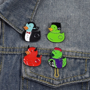 Halloween duck enamel pins set displayed on the collar of a blue denim jacket