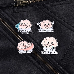 Detail of four cute brain enamel pins with humorous slogans on black leather jacket