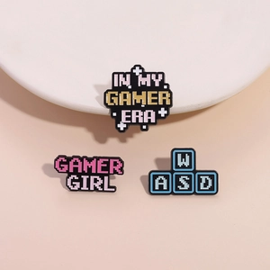 Three-piece retro pixel enamel pin set featuring Gamer Era and WASD keyboard designs